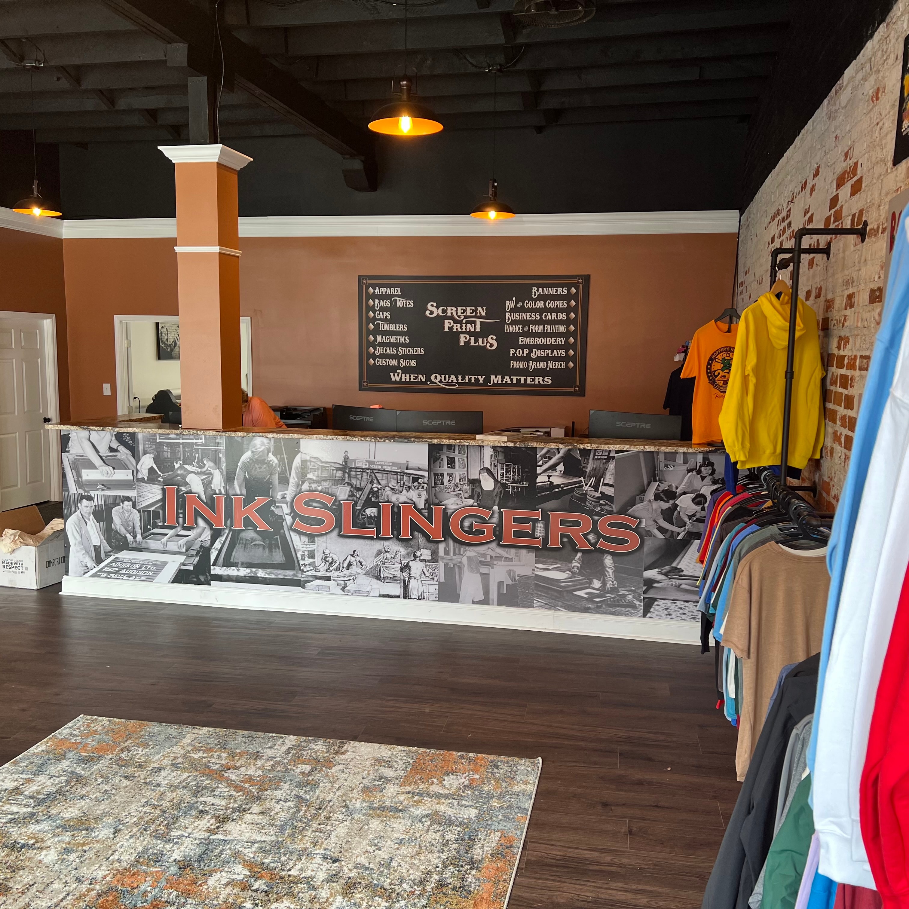 Screen Print Plus shop interior — Ink Slingers counter and apparel displays